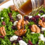 image of kale salad dressing being poured onto salad