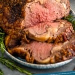 pinterest graphic of a prime rib that has been sliced, says: "tried and true prime rib recipe, simplejoy.com"