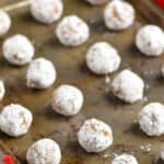 rum ball recipe rolled in powdered sugar and on a baking sheet