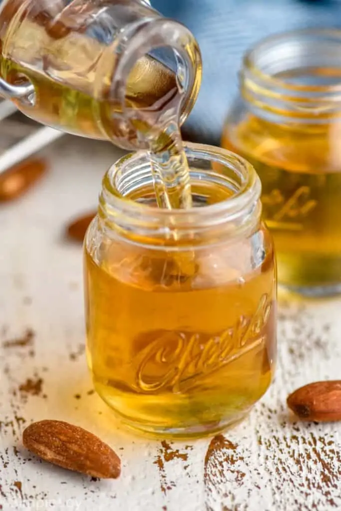 amaretto liqueur being poured into a small shot glass