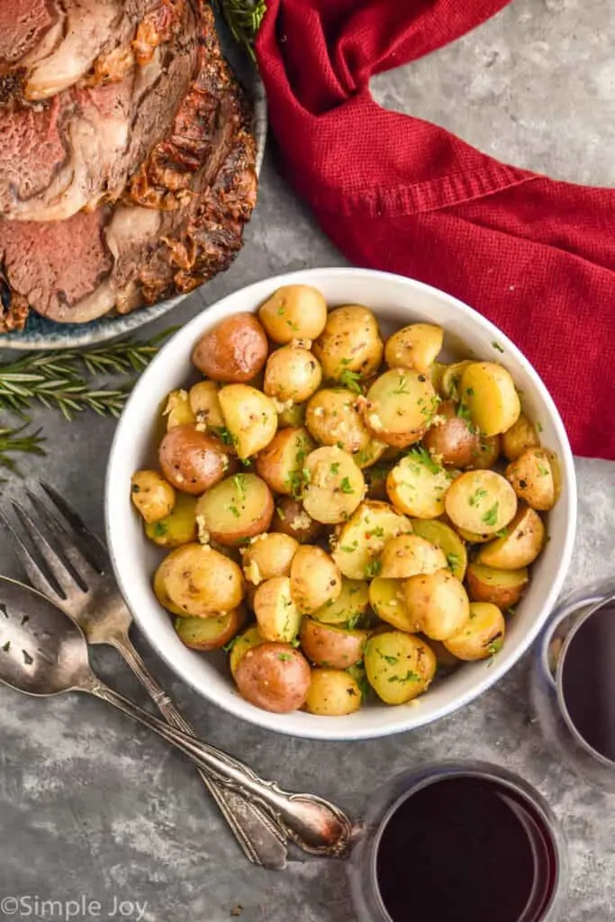 overhead view of a bowl of prepared baby potatoes recipe garnished with parsley