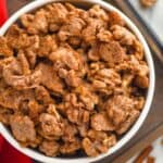 overhead view of candied walnuts in a big white bowl on a tray - 9