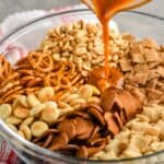 Chex mix seasoning being poured over the ingredients - 10