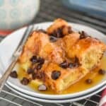 a square piece of croissant bread pudding smothered in brown sugar sauce - 7