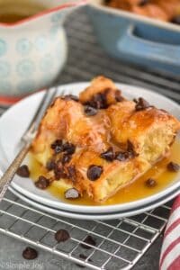a square piece of croissant bread pudding smothered in brown sugar sauce