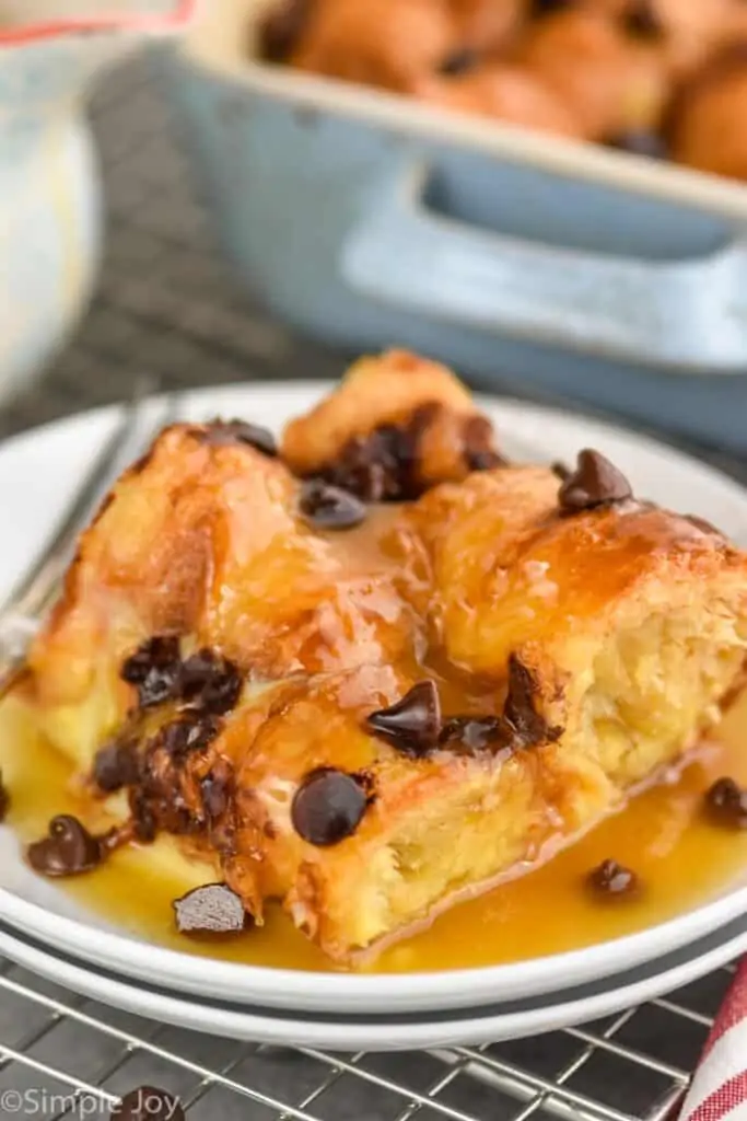 a square piece of croissant bread pudding smothered in brown sugar sauce