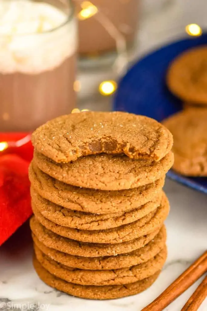 stack of molasses cookies with the top one missing a bite