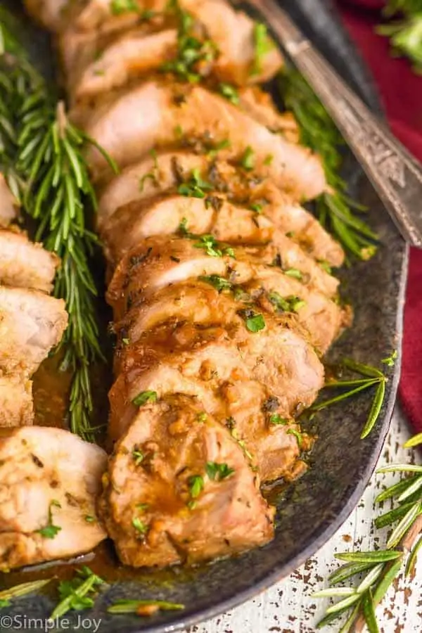 close up of a pork tenderloin recipe cut up and on a serving platter