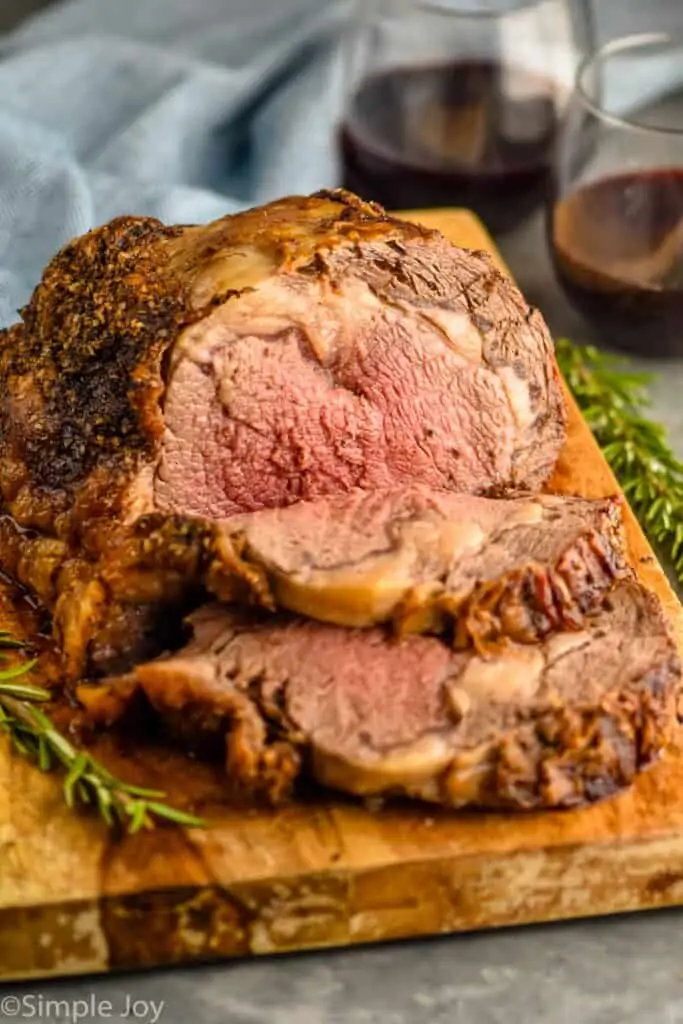 a prime rib roast recipe on a cutting board that has been sliced into