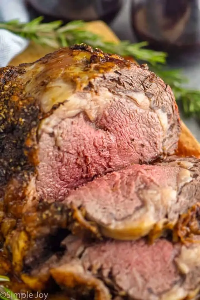 prime rib roast on a cutting board after being sliced into