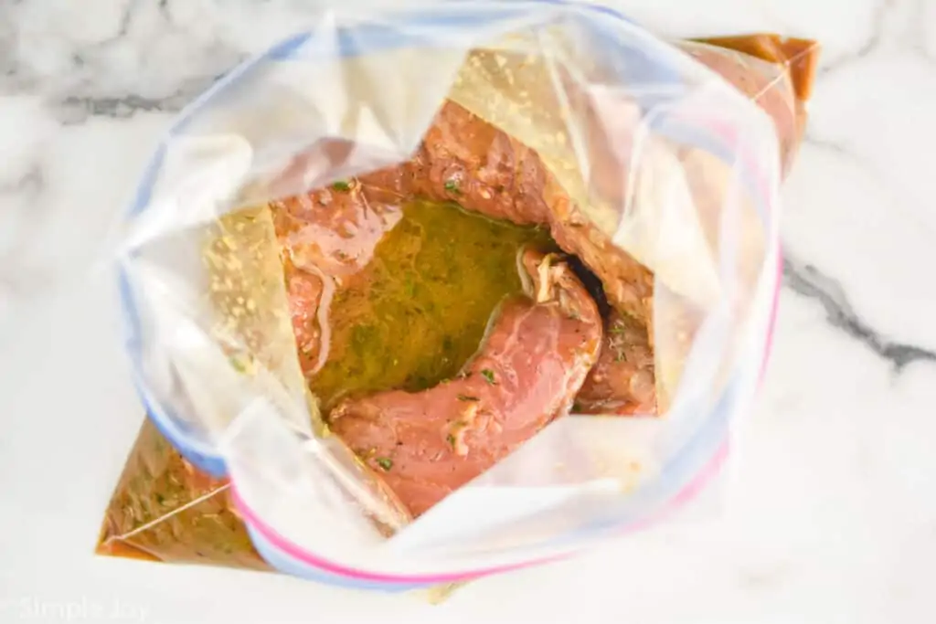 overhead view of pork tenderloin marinade with pork in it