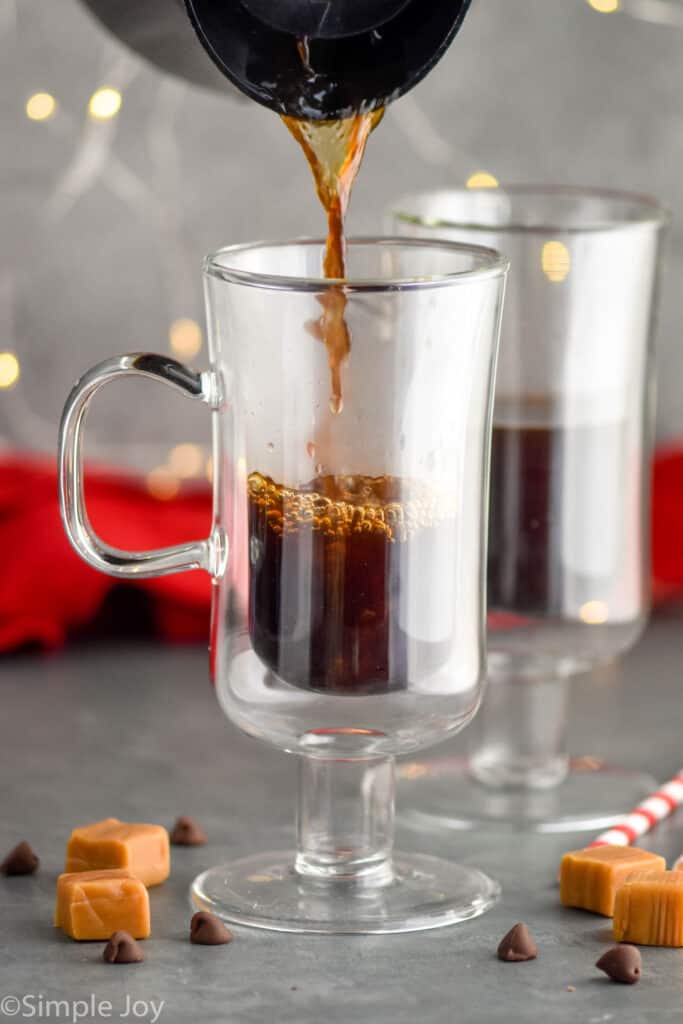 coffee being poured into an Irish coffee glass