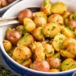 small potatoes recipe garnished with parsley in a serving bowl
