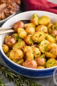 small potatoes recipe garnished with parsley in a serving bowl