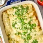 overhead photo of green enchiladas in a casserole dish topped with cilantro