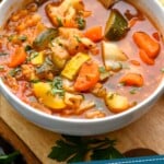 pinterest graphic of a white bowl of vegetable soup, says: "healthy and easy vegetable soup, simplejoy.com"