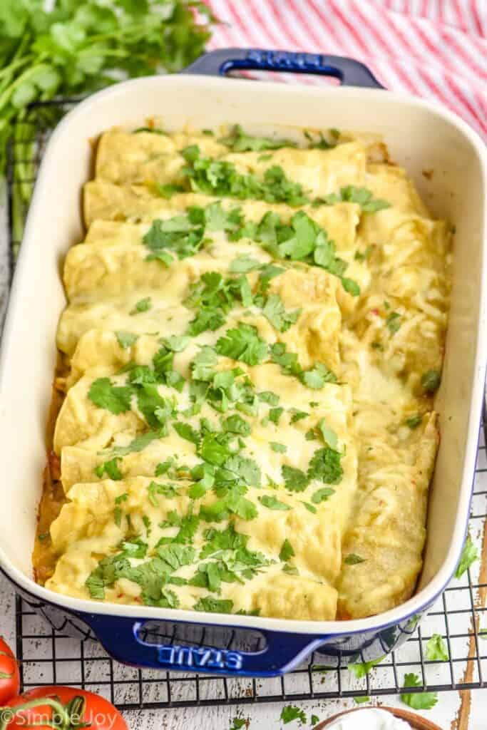 side view of a casserole dish full of green chicken enchiladas