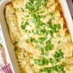 overhead photo of green enchiladas in a casserole dish topped with cilantro - 10