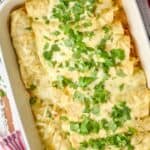 overhead photo of green enchiladas in a casserole dish topped with cilantro