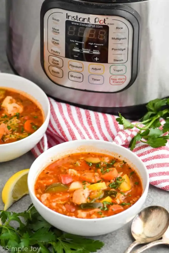 pulled back view of two boys of soup in front of an instant pot