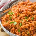 a bowl of Spanish rice garnished with cilantro - 5