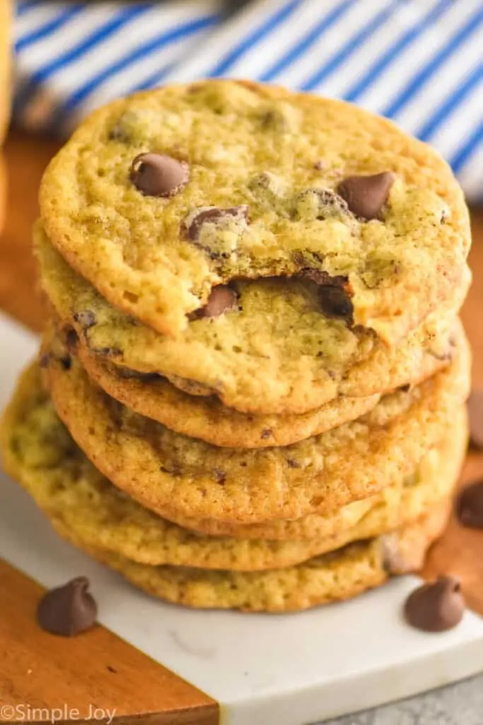 stack of banana chocolate chip cookies with the top one missing a bite