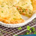 pinterest graphic of a pie plate full of easy chicken pot pie with a piece missing, garnished with parsley