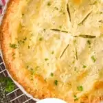 pinterest graphic of overhead photo of a whole chicken pot pie with tiny pieces of parsley
