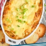 pinterest graphic of overhead photo of a casserole dish with hot crab dip, says: "hot crab dip, simplejoy.com"
