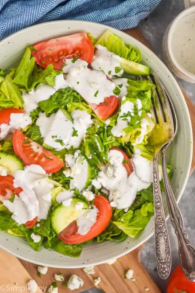 overhead view of a bowl of salad with blue cheese dressing
