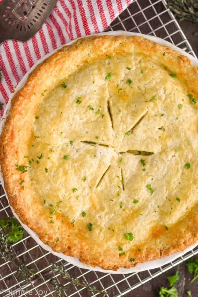 overhead photo of a whole chicken pot pie with tiny pieces of parsley