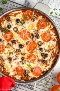 overhead of a skillet full of one pot pizza casserole recipe, garnished with fresh parsley