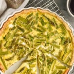 pinterest graphic of overhead picture of an asparagus quiche that has pieces cut out