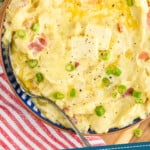 Pinterest graphic showing close up overhead of a bowl of colcannon with two pads of butter and diced scallions