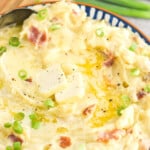 pinterest graphic showing side view of a bowl of colcannon recipe with scallions on top