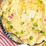 Pinterest graphic showing close up overhead of a bowl of colcannon with two pads of butter and diced scallions
