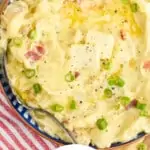 Pinterest graphic showing close up overhead of a bowl of colcannon with two pads of butter and diced scallions