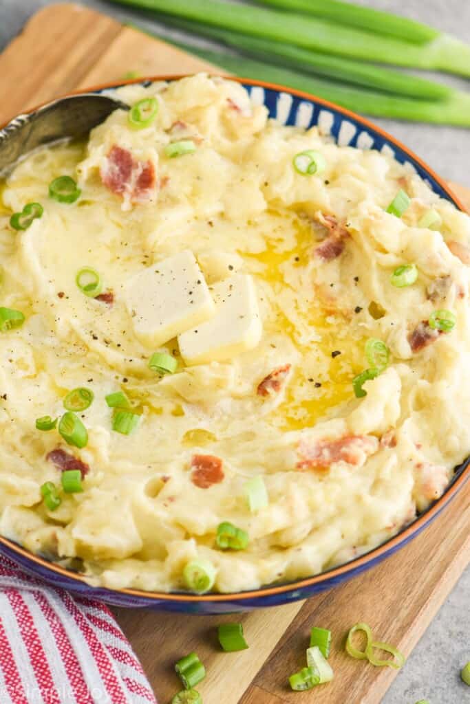 side view of a bowl of colcannon recipe with scallions on top