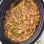 overhead photo of a slow cooker full of beef and noodles - 9