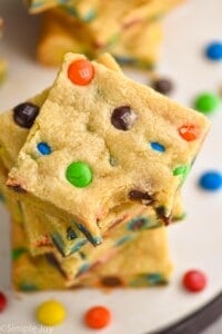 overhead view of a stack of cookie bars with m&ms in them