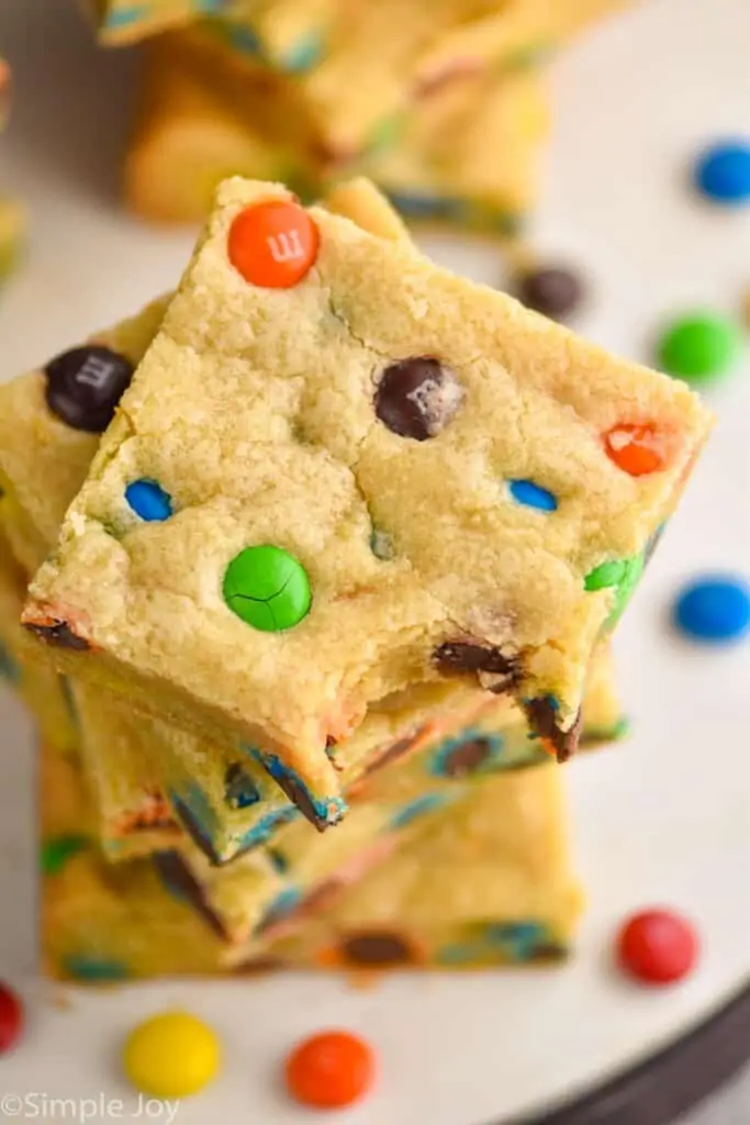overhead view of a stack of cookie bars with m&ms in them