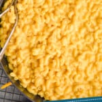 Pinterest graphic of close up overhead view of Mac and cheese recipe in a skillet with two spoons dug in