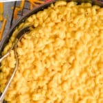 pinterest graphic of close up overhead view of Mac and cheese recipe in a skillet with two spoons dug in