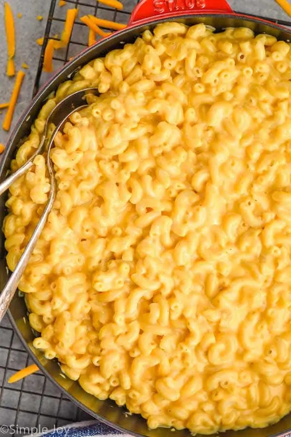 close up overhead view of Mac and cheese recipe in a skillet with two spoons dug in