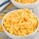 two small white bowls pilled high with macaroni and cheese recipe