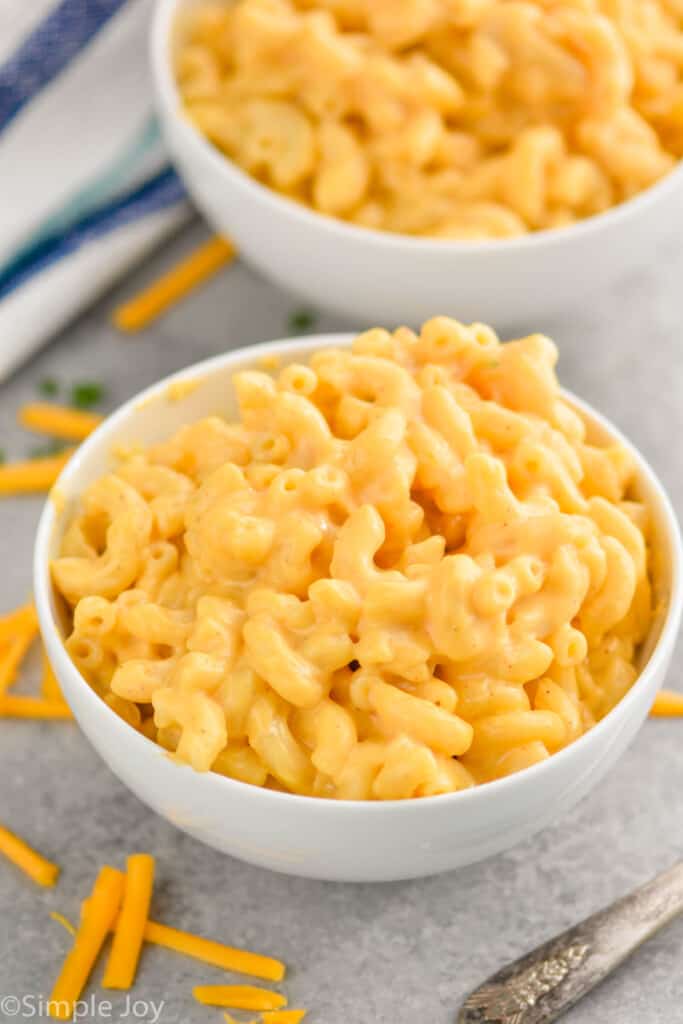 two small white bowls pilled high with macaroni and cheese recipe