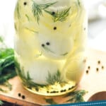pinterest graphic a jar of pickled egg recipe with fresh dill, onions, and pepercorns