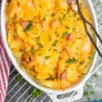 pinterest graphic of overhead view of a casserole dish with scalloped potatoes and ham