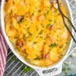 pinterest graphic of overhead view of a casserole dish with scalloped potatoes and ham