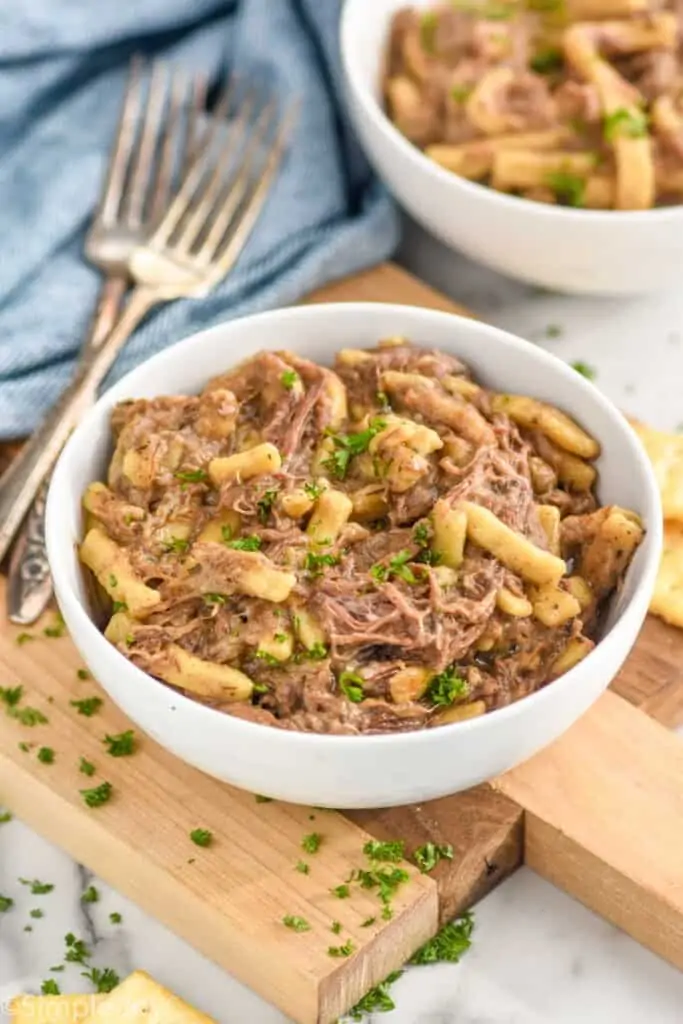 side view of shredded beef made in the slow cooker with egg noodles